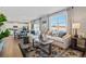 Inviting living room with a large sofa, neutral decor, and expansive windows offering views at 4853 Cattle Cross Ln, Castle Rock, CO 80104