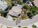Bird's eye view of a meticulously landscaped property with a tiled roof and backyard pergola at 9734 Tall Grass Cir, Lone Tree, CO 80124