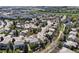 Residential aerial view of a community, showcasing the golf course and scenic mountain views in the background at 9734 Tall Grass Cir, Lone Tree, CO 80124