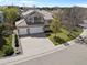 Aerial view of a two-story home with three-car garage, lush lawn, and tile roof at 9734 Tall Grass Cir, Lone Tree, CO 80124