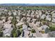 Aerial view of a residential neighborhood near a golf course and mountains, offering a serene living environment at 9734 Tall Grass Cir, Lone Tree, CO 80124