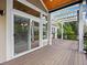 Covered back porch featuring sliding glass doors and a pergola at 9734 Tall Grass Cir, Lone Tree, CO 80124