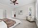 Bright bedroom with neutral tones, plush carpet, a cozy armchair, and an ensuite bathroom, creating a tranquil retreat at 9734 Tall Grass Cir, Lone Tree, CO 80124