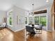 Eat-in dining area features many windows, access to deck, and chandelier lighting at 9734 Tall Grass Cir, Lone Tree, CO 80124