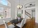 Dining room features a chandelier and many windows with access to the staircase at 9734 Tall Grass Cir, Lone Tree, CO 80124