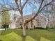 Charming stucco home featuring a well-manicured lawn and inviting, arched entryway at 9734 Tall Grass Cir, Lone Tree, CO 80124