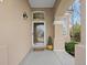 Inviting front porch with decorative light fixture and a glimpse of the home's exterior at 9734 Tall Grass Cir, Lone Tree, CO 80124