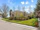Well-maintained front yard with mature trees, lush lawn, and charming landscaping at 9734 Tall Grass Cir, Lone Tree, CO 80124