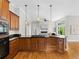 Well-equipped kitchen featuring wooden cabinetry, granite countertops, and hardwood floors at 9734 Tall Grass Cir, Lone Tree, CO 80124