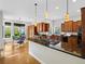 Spacious kitchen featuring stainless steel appliances, dark countertops, and a central island cooktop at 9734 Tall Grass Cir, Lone Tree, CO 80124