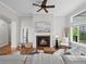 Inviting living room with a brick fireplace, hardwood floors, and a comfortable gray sofa, creating a cozy atmosphere at 9734 Tall Grass Cir, Lone Tree, CO 80124