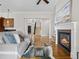 Bright living room boasts hardwood floors, a fireplace, and an open entryway at 9734 Tall Grass Cir, Lone Tree, CO 80124