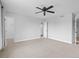 Spacious primary bedroom with neutral carpet, ceiling fan, and ensuite bathroom access at 9734 Tall Grass Cir, Lone Tree, CO 80124