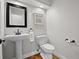 Clean powder room featuring a pedestal sink, sleek fixtures, and classic white walls, creating a minimalist design at 9734 Tall Grass Cir, Lone Tree, CO 80124
