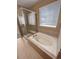 Bathroom featuring a soaking tub, a tiled shower, and modern fixtures at 1220 W 170Th Ave, Broomfield, CO 80023