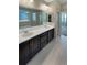 Elegant bathroom featuring dual sinks, tile flooring, and a glass-enclosed shower at 1220 W 170Th Ave, Broomfield, CO 80023