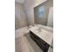 Bathroom featuring a vanity with dark cabinets and a tiled shower-tub combo at 1220 W 170Th Ave, Broomfield, CO 80023