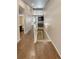 Hallway features hardwood floors, stairway to lower level and access to kitchen and bathroom at 1220 W 170Th Ave, Broomfield, CO 80023