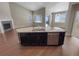 Spacious kitchen island featuring a sink, dishwasher, and granite countertop at 1220 W 170Th Ave, Broomfield, CO 80023