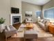 Staged living room featuring high ceilings, fireplace, and hardwood floors at 1220 W 170Th Ave, Broomfield, CO 80023