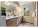 Bathroom with a double sink vanity, tile floor, and large window with a view at 33095 Bergen Mountain Rd, Evergreen, CO 80439