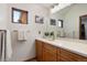 Bathroom featuring a single sink vanity, white countertops, and a window at 33095 Bergen Mountain Rd, Evergreen, CO 80439