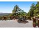 Outdoor deck with a table and chairs and scenic mountain views at 33095 Bergen Mountain Rd, Evergreen, CO 80439