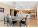 Open-concept dining room with modern table set and access to the kitchen at 33095 Bergen Mountain Rd, Evergreen, CO 80439