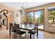 Bright dining room with deck access, mountain views, and modern light fixtures at 33095 Bergen Mountain Rd, Evergreen, CO 80439