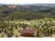 Aerial view of home featuring mountain views and natural surroundings with mature trees at 33095 Bergen Mountain Rd, Evergreen, CO 80439
