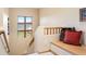 Bright hallway with a large window providing scenic mountain views, complemented by a cozy built-in bench seating area at 33095 Bergen Mountain Rd, Evergreen, CO 80439