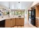 Modern kitchen with white countertops, wood cabinets, and stainless-steel appliances at 33095 Bergen Mountain Rd, Evergreen, CO 80439