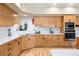 Bright kitchen with stainless appliances, wood cabinets, and tile backsplash at 33095 Bergen Mountain Rd, Evergreen, CO 80439