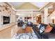 Open-concept living room with hardwood floors, a stone fireplace, and access to the dining area at 33095 Bergen Mountain Rd, Evergreen, CO 80439