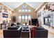 Bright living room with vaulted ceilings, a stone fireplace, and mountain views at 33095 Bergen Mountain Rd, Evergreen, CO 80439