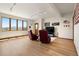 Bright living room featuring wood floors, large windows with mountain views, and comfortable seating area at 33095 Bergen Mountain Rd, Evergreen, CO 80439