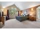 Bedroom featuring vaulted ceiling, windows with great views, wood dresser, and rocking chair at 33095 Bergen Mountain Rd, Evergreen, CO 80439