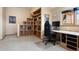 Office space with large windows, built in bookshelves, and a desk at 33095 Bergen Mountain Rd, Evergreen, CO 80439