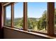 Expansive window view of rolling hills and trees at 33095 Bergen Mountain Rd, Evergreen, CO 80439