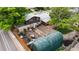 An aerial shot of a home's backyard with a large, green protective cover, a small patch of grass, and a wooden fence at 147 Wallace St, Northglenn, CO 80234
