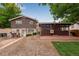 Photograph of the back of a two-story home with mixed materials, a porch with brick flooring, and a partly grassy area at 147 Wallace St, Northglenn, CO 80234