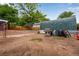 Backyard area featuring a green protective cover, a grill, and an assortment of equipment and accessories at 147 Wallace St, Northglenn, CO 80234