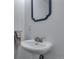 This bathroom includes a pedestal sink, a towel rack, and a decorative mirror at 147 Wallace St, Northglenn, CO 80234