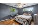 Serene bedroom with hardwood floors, a desk, and floral bedding, offering a relaxing retreat at 147 Wallace St, Northglenn, CO 80234