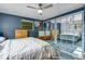 Comfortable bedroom with hardwood floors, ceiling fan, TV, and mirrored closet, providing a relaxing atmosphere at 147 Wallace St, Northglenn, CO 80234