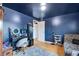 Stylish bedroom with a vanity, zebra seating, blue walls, and hardwood floors, creating a chic atmosphere at 147 Wallace St, Northglenn, CO 80234