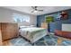 Spacious bedroom with natural light, hardwood floors, with a flat screen TV and patterned rug, creating a relaxing space at 147 Wallace St, Northglenn, CO 80234