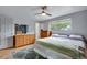 Bright bedroom with hardwood floors, dresser, and window, providing a tranquil and airy retreat at 147 Wallace St, Northglenn, CO 80234