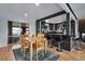 Open dining area featuring a modern kitchen, bar seating, and a sliding glass door at 147 Wallace St, Northglenn, CO 80234