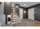 Inviting entryway with wood stairs, neutral gray walls, and two white doors, providing a stylish entrance at 147 Wallace St, Northglenn, CO 80234